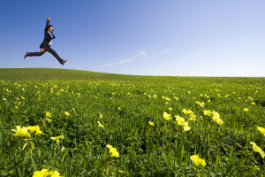 Businessman jumping on the field